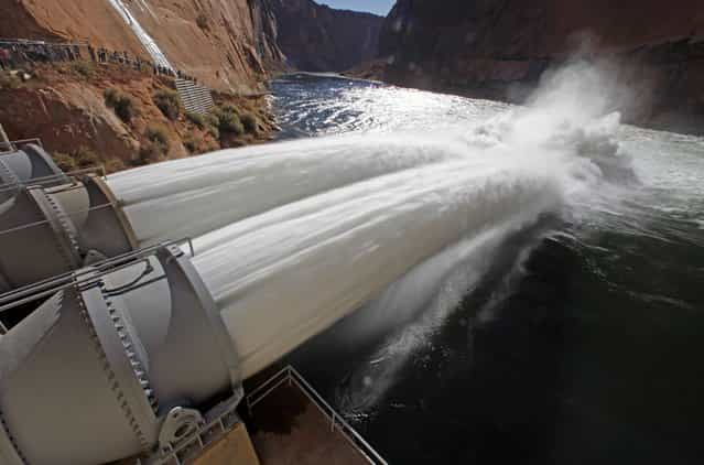 Water pours from river outlet tubes during an experimental high flow release from the Glen Canyon Dam in Page, Arizona, November 19, 2012. The total maximum release from the dam will reach approximately 42,300 cubic feet per second – 27,300 cfs of full-capacity powerplant releases and a bypass release through four river outlet tubes sending 15,000 cfs of water out over the Colorado River, according to an Interior Department statement. The release is part of a long-term protocol announced in May by Interior Secretary Ken Salazar to meet water and power needs and resolve problems with downstream sediment and non-native fish predation on the Colorado River below the dam. (Photo by Bob Strong/Reuters) 