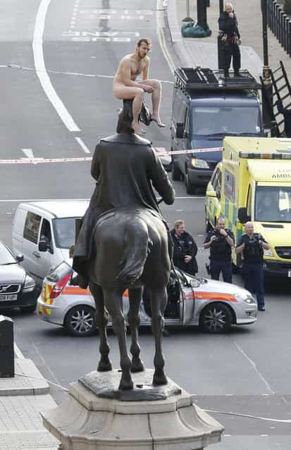 An unidentified man sits naked on top of the statue of Prince George, Duke of Cambridge outside the Ministry of Defence building in Whitehall in central London on November 23, 2012. The man, who brought Whitehall to a standstill for almost two hours, stood naked on the statue and struck various poses before being eventually talked down. (Photo by Justin Tallis/AFP Photo) An unidentified man sits naked on top of the statue of Prince George, Duke of Cambridge outside the Ministry of Defence building in Whitehall in central London on November 23, 2012. The man, who brought Whitehall to a standstill for almost two hours, stood naked on the statue and struck various poses before being eventually talked down. (Photo by Justin Tallis/AFP Photo)