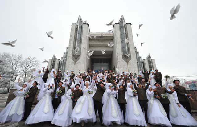 Kyrgyz couples take part in a mass wedding ceremony in the capital Bishkek on November 13, 2012. Thirty-five couples took part in the mass wedding sponsored by a state company. (Photo by Vyacheslav Oseledko/AFP Photo)