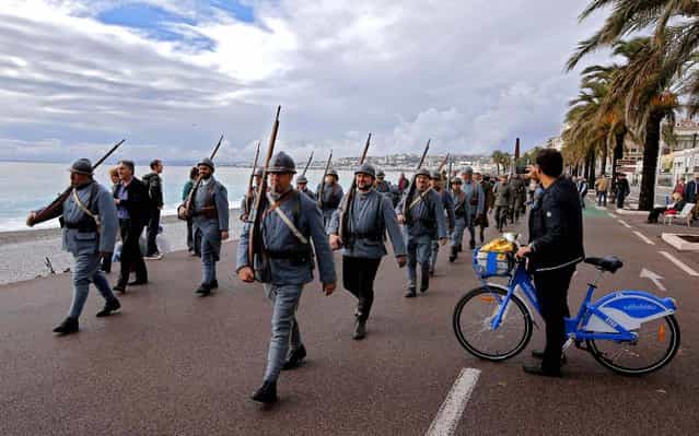Citizens of the southern French town of Nice, wearing [Poilu] or French World War I infantry uniforms, parade on the city's promenade des Anglais during an Armistice Day ceremony, November 11, 2012. November 11 marks the signing of the truce that ended the fighting in World War I , and is the day the more than 1 million French soldiers killed in that war are memorialized. (Photo by Lionel Cironneau/Associated Press)