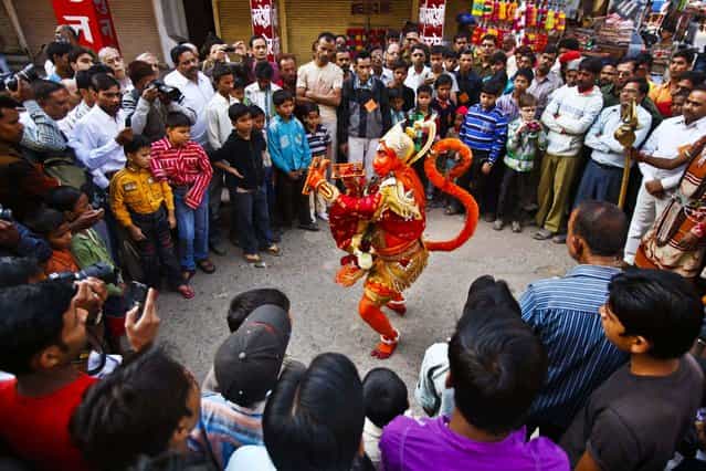 A man dressed as a monkey god Hanuman participates in a religious procession ahead of Diwali, the Hindu festival of light, in Allahabad, India, November 13, 2012. (Photo by Rajesh Kumar Singh/Associated Press)