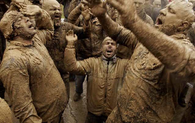 Mourners chant slogans as they cover themselves with mud during Ashoura rituals, marking the anniversary of the death of Imam Hussein, the grandson of Islam's Prophet Muhammad, in Bijar, west of Tehran, Iran, November 25, 2012. Hussein, one of Shiite Islam's most beloved saints, was killed in a 7th century battle at Karbala, Iraq. (Photo by Vahid Salemi/Associated Press)