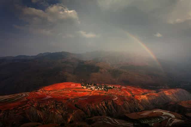 [Red Land: Sunset Cloud Village is one of the most picturesque places in Red Land, China. As its name indicates, it's best to see before sunset. The reddish brown soil turns redder after rainfall and after farmers plow the land]. (Photo and comment by Peng Jiang/National Geographic Photo Contest via The Atlantic)