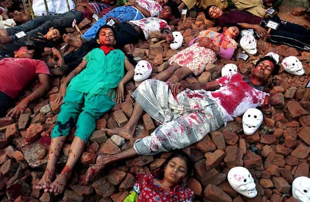 Children of Khelaghor organizations stage a mock scene of the killings of intellectuals to observe Martyrs' Day, in Dhaka, Bangladesh, December 14, 2012. Martyrs' Day comemorates the intellectuals who were killed on this day during the country's independence war against Pakistan in 1971. (Photo by A.M.Ahad/Associated Press)