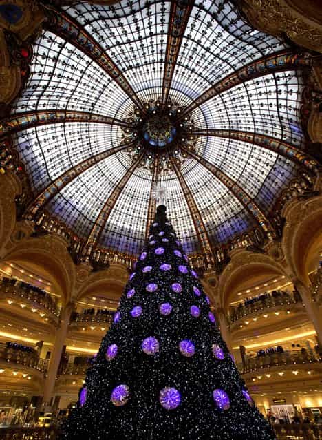 A Christmas tree is seen in the main hall of the Galeries Lafayette department store in Paris, December 18, 2012. (Photo by Michel Euler/Associated Press)