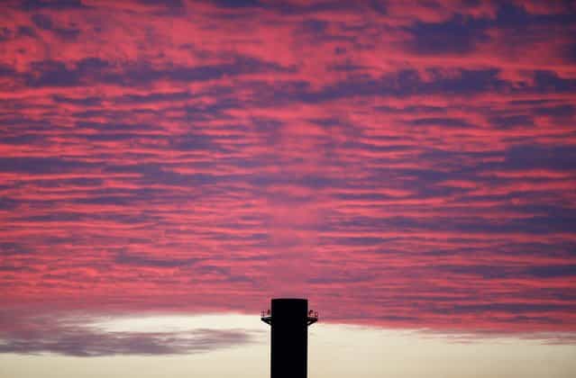 One of the chimneys of the Marsa power station is seen at sunset outside Valletta December 16, 2012. The most polluting and least efficient boilers at the Marsa power station have been shut down after an extension at another more modern power station came online. The government has admitted that it would not be in a position to completely shut down the Marsa power station before sometime in 2013, despite the fact that its operation is in breach of EU rules, according to local media. (Photo by Darrin Zammit Lupi/Reuters)
