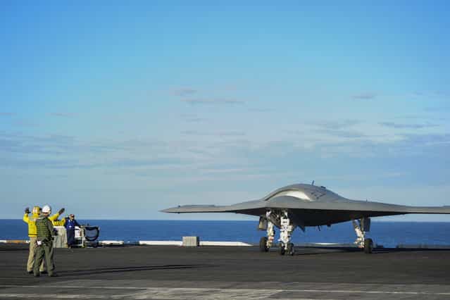 The X-47B Unmanned Combat Air System (UCAS) demonstrator taxies on the flight deck of the aircraft carrier USS Harry S. Truman (CVN 75). Harry S. Truman is the first aircraft carrier to host test operations for an unmanned aircraft, December 9, 2012. Harry S. Truman is underway supporting carrier qualifications. (Photo by U.S. Navy photo courtesy of Northrop Grumman Corp. by Alan Radecki/AFP Photo)