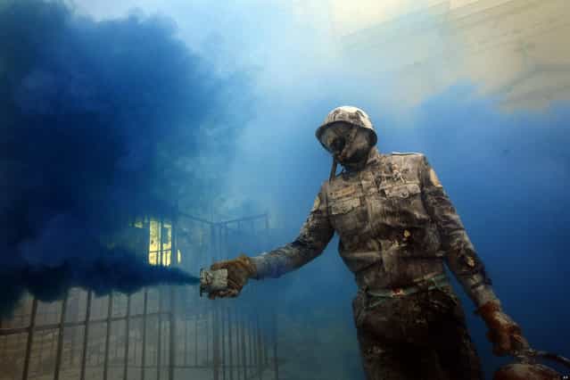A reveler takes part in festival of Els Enfarinats, in the town of Ibi near Alicante, Spain, Friday, December 28, 2012. For 200 years the inhabitants of Ibi annually celebrate with a battle using flour, eggs and firecrackers, outside the city town hall. (Photo by Alberto Saiz/AP Photo)