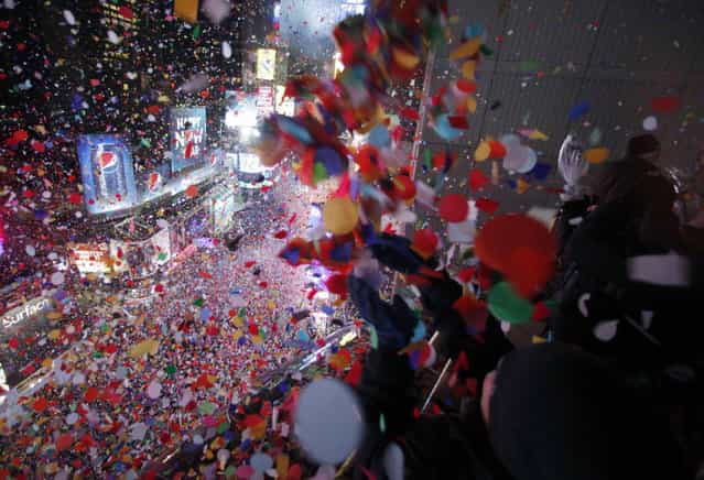 Confetti is dropped on revelers at midnight during New Year celebrations in Times Square in New York January 1, 2013. (Photo by Gary Hershorn/Reuters)