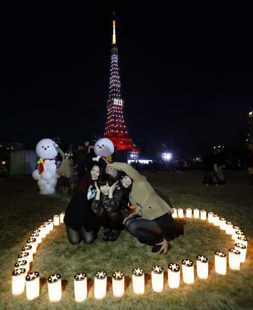 People take a picture in front of Tokyo Tower which is illuminated to celebrate the New Year, after a countdown event early Tuesday morning. (Photo by Japan Today)