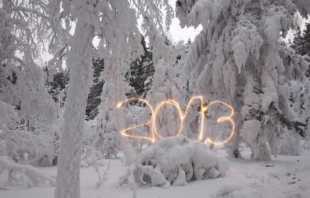 A reveller writes the number 2013 with sparklers ahead of New Year's Day at an air temperature of about -25 degrees Celsius (-13 F) in a forest outside Russia's Siberian city of Krasnoyarsk December 31, 2012. Picture taken with long exposure on December 31, 2012. (Photo by Ilya Naymushin/Reuters)