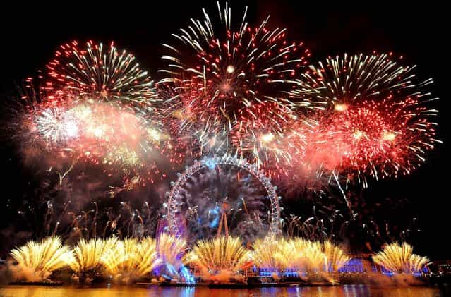 Fireworks explode over the London Eye during New Year celebrations. (Photo by Dominic Lipinski/Press Association)