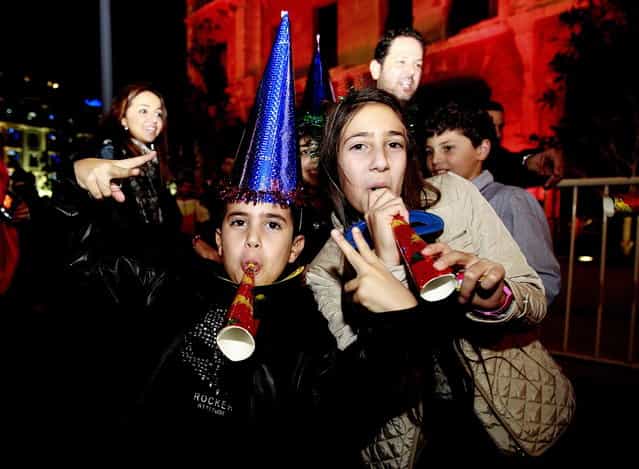 Lebanese children celebrate on new year's eve in Beirut, early on January 1, 2013. (Photo by Anwar Amro/AFP Photo)