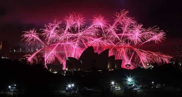 Fireworks explode above Sydney Harbour during celebrations in Sydney, Australia. (Photo by Rob Griffith/Associated Press)