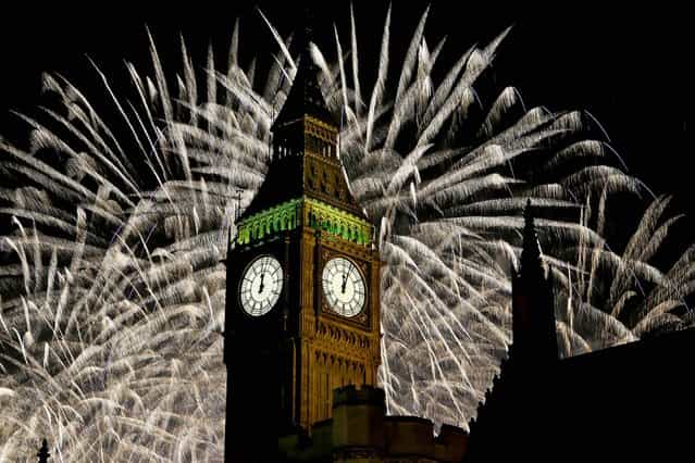 Fireworks explode over Elizabeth Tower in London. (Photo by Kirsty Wigglesworth/Associated Press)