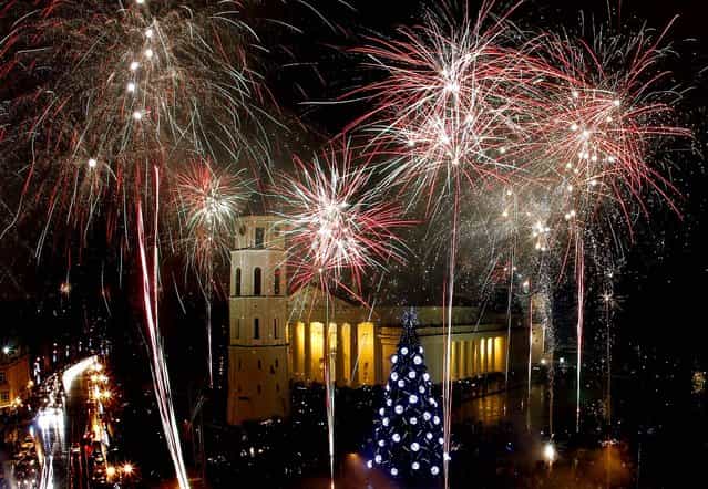 Fireworks light the sky above Cathedral Square in Vilnius, Lithuania. (Photo by Mindaugas Kulbis/Associated Press)