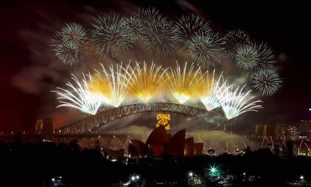 Fireworks explode above Sydney Harbour during celebrations in Sydney, Australia. (Photo by Rob Griffith/Associated Press)