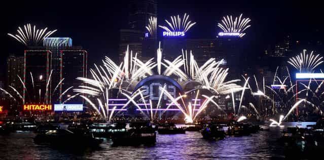 Fireworks explode at the Hong Kong Convention and Exhibition Centre over Victoria Harbor. (Photo by Kin Cheung/Associated Press)