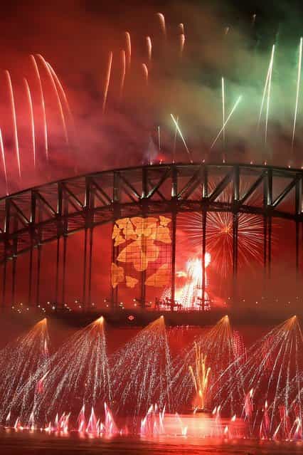 Fireworks light up the sky from The Sydney Harbour Bridge at midnight during New Years Eve celebrations on Sydney Harbour on December 31, 2012 in Sydney, Australia. (Photo by Cameron Spencer)
