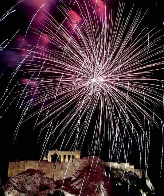 Fireworks explode over Acropolis Hill and the Parthenon during celebrations in Athens. (Photo by Dimitri Messinis/Associated Press)