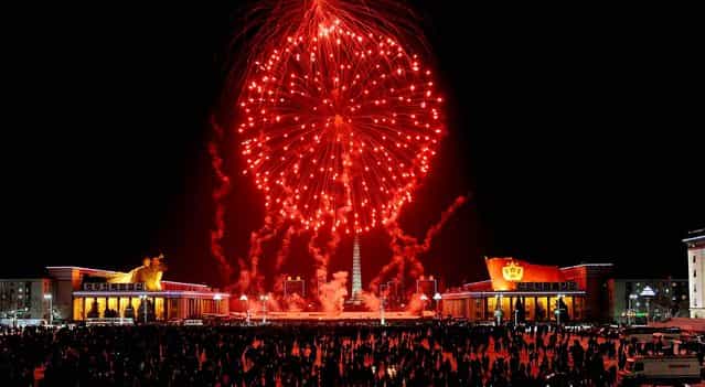 Fireworks explode over Kim Il Sung Square in Pyongyang, North Korea. (Photo by Kyodo News)