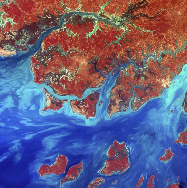 Guinea-Bissau. Guinea-Bissau is a small country in West Africa. Complex patterns can be seen in the shallow waters along its coastline, where silt carried by the Geba and other rivers washes out into the Atlantic Ocean. This is a false-color composite image made using infrared, red and blue wavelengths to bring out details in the silt. Image taken December 1st, 2000, by Landsat 7. (Photo by NASA/GSFC/USGS EROS Data Center)