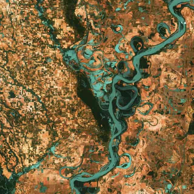 Meandering Mississippi. Small, blocky shapes of towns, fields, and pastures surround the graceful swirls and whorls of the Mississippi River. Countless oxbow lakes and cutoffs accompany the meandering river south of Memphis, Tennessee, on the border between Arkansas and Mississippi, USA. The [mighty Mississippi] is the largest river system in North America. This image, taken by Landsat 7 on May 28, 2003, won 3rd place in the online [Earth as Art] competition to celebrate the 40th anniversary of the Landsat satellite program. (Photo by NASA/GSFC/USGS EROS Data Center)