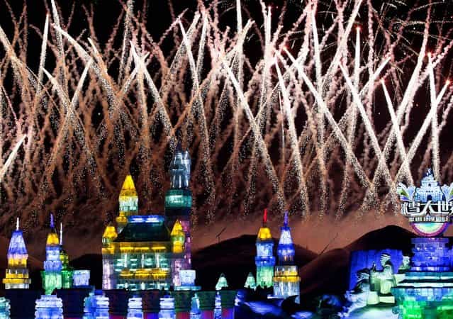 Fireworks explode over ice sculptures during the official opening of the 29th Harbin International Ice and Snow Festival on January 5, 2013. (Photo by Associated Press)