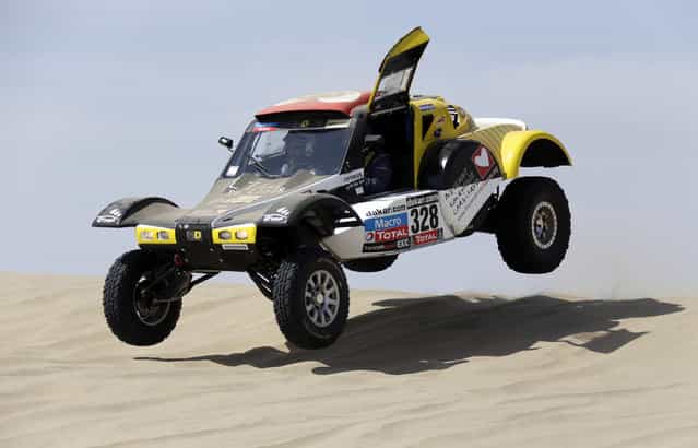 France's Pascal Thomasse and co-pilot Pascal Larroque compete with their Buggy MD Rallye during the first stage of the Dakar Rally 2013 from Lima to Pisco January 5, 2013. (Photo by Jacky Naegelen/Reuters)