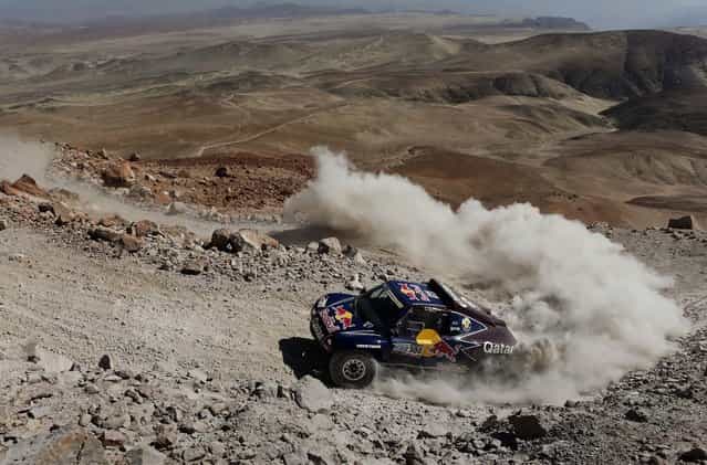 Driver Nasser Al-Attiyah of Qatar and co-driver Lucas Cruz of Spain compete in the 4th stage. (Photo by Victor R. Caivano/Associated Press)