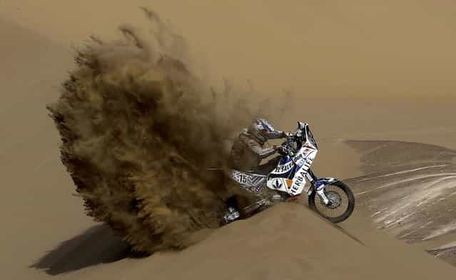 KTM rider Jorge Aguilar of Salvador tries to get out of a dune during the 6th stage of the 2013 Dakar Rally from Arica to Calama, Chile, Thursday, January 10, 2013. The race finishes in Santiago, Chile, on January 20. (Photo by Victor R. Caivano/AP Photo)