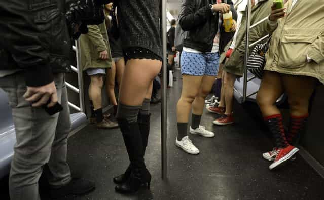 Some riders in the New York City subway in the underwear as the take part in the 2013 No Pants Subway Ride January 13, 2013. Started by Improv Everywhere, the goal is for riders to get on the subway train dressed in normal winter clothes (without pants) and keep a straight face. AFP PHOTO / TIMOTHY A. CLARY (Photo credit should read TIMOTHY A. CLARY/AFP/Getty Images)