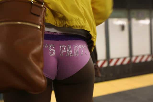 NEW YORK, NY - JANUARY 13: A pantless woman stands on a subway platform on January 13, 2013 in New York City. Thousands of people participated in the 12th annual No Pants Subway Ride, organized by New York City prank collective Improv Everywhere. During the afternoon winter event, participants boarded separate subway stops and removed their pants, pretending that they did not know each other. The event, refered to as a "celebration of silliness" is designed to make fellow subway riders laugh and smile. (Photo by John Moore/Getty Images)