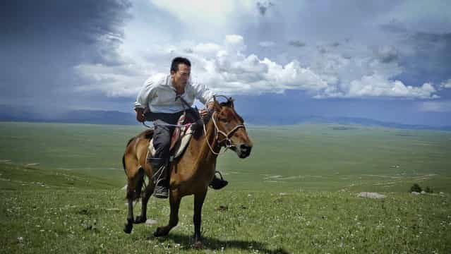 Mongolia, 2009. Research scientist and National Geographic Emerging Explorer Albert Lin gallops across the steppes of northern Mongolia as he searches for Genghis Khan's tomb and other archaeological sites. (Photo by Mike Hennig