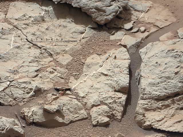 This image of an outcrop at the [Sheepbed] locality, taken by NASA's Curiosity Mars rover with its right MastCam on December 13, show well-defined veins filled with whitish minerals, interpreted as calcium sulfate. These veins form when water circulates through fractures, depositing minerals along the sides of the fracture, to form a vein. This is Curiosity's first close look at minerals that formed within water that percolated within a subsurface environment. (Photo by NASA)