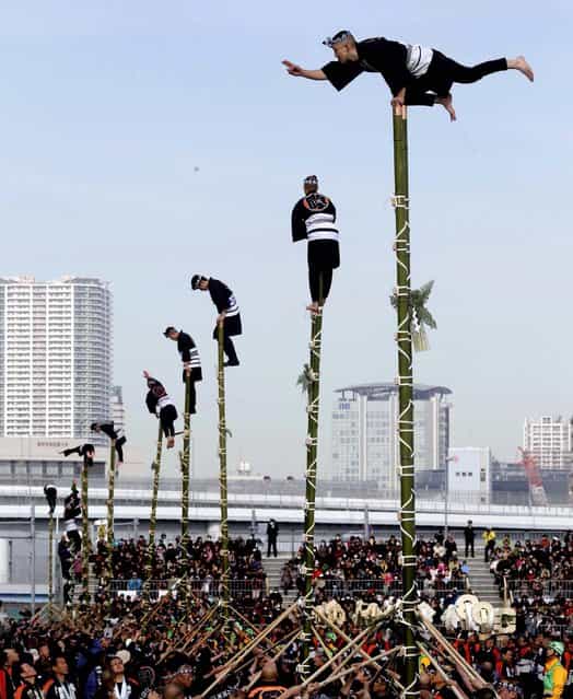 Members of a traditional firefighting preservation group perform on top of bamboo ladders during the annual New Year's Fire Brigade Review in Tokyo, January 6, 2013. (Photo by Shizuo Kambayashi/Associated Press)