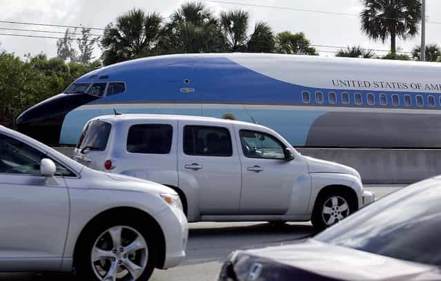A replica of Air Force One travels on a flatbed truck eastbound on Southern Blvd. to the South Florida Fairgrounds in West Palm Beach, January 9, 2013. The 65-foot by 12-foot fuselage replicates the Air Force One that was used for nearly three decades, from President John F. Kennedy through President Ronald Reagan. The South Florida Fair's Exposition Hall will take on a presidential look later in the month. A number of new attractions will be set up in the 70,000 square foot expo space with the theme, [Washington, D.C., Our Nation's Capital]. (Photo by Allen Eyestone/The Palm Beach Post)
