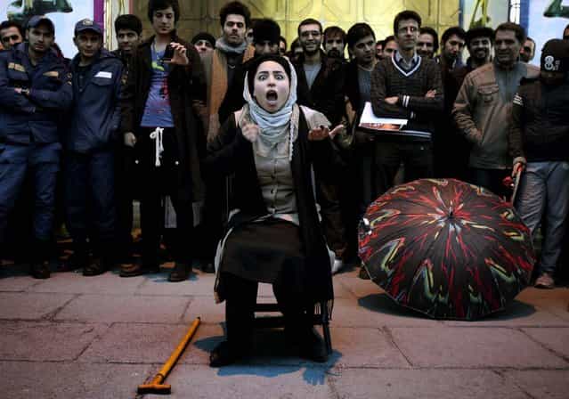 Iranian actress Elaheh Pourjamshid performs her role as a mother in [Awakening of The Particles] street theater, telling a story about children's education, during the 31st Fajr International Theater Festival in Tehran, January 17, 2013. The Fajr festival is the most important theatrical event in the country and marks the anniversary of the 1979 Islamic revolution. (Photo by Vahid Salemi/Associated Press)