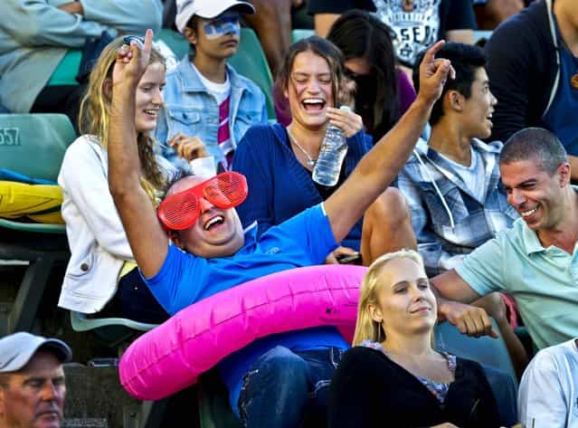 An Australia supporter celebrates a point during the first round match between Madison Keys of the United States and Australia's Casey Dellacqua during the Australian Open tennis championship in Melbourne, January 14, 2013. (Photo by Andy Wong/Associated Press)