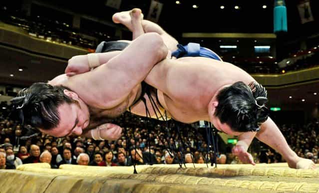 Junior champion Goeido, right, throws champion Kotooshu to win his bout during the 15-day New Year Grand Sumo tournament in Tokyo, January 17, 2013. (Photo by Kyodo News/Associated Press)