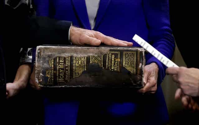Vice President Joe Biden places his hand on the Biden Family Bible, held by his wife Jill Biden, as he takes the oath of office from Supreme Court Justice Sonia Sotomayor during the official swearing-in ceremony at the Naval Observatory, on January 20, 2013. (Photo by Carolyn Kaster/Associated Press)