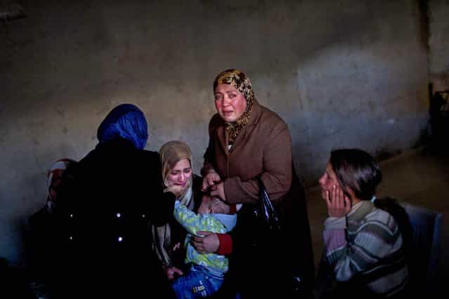 Relatives and friends of Lubna Hanash mourn during her funeral in Bethlehem. Israeli soldiers shot and killed Lubna near the West Bank town of Hebron, said Kamil Hmaid, the Palestinian governor of the Hebron district, January 23, 2013. The Israeli military said soldiers were attacked with firebombs and fired back. The 22-year-old woman was driving in a car when she was shot. (Photo by Bernat Armangue/Associated Press)