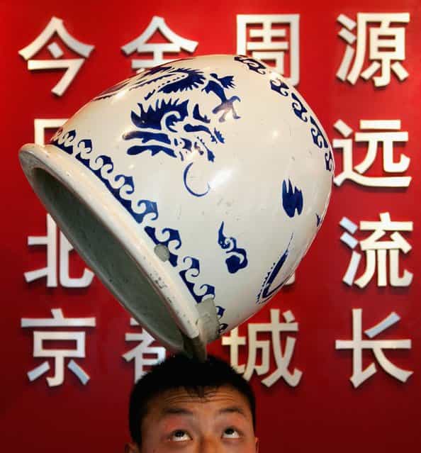 A young man performs acrobatics at The First China Beijing International Cultural and Creative Industry Expo in Beijing. China. (Photo by Guang Niu)