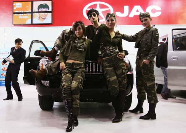 Chinese models promote a domestic car at Auto Exhibit Trade Show of Beijing in Beijing, China. (Photo by Guang Niu)