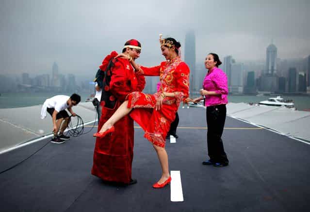 Competitors dance before the Hong Kong skyline as they take part in a Red Bull [Flugtag] event in the West Kowloon district of the city. (Photo by Ed Jones/AFP Photo)