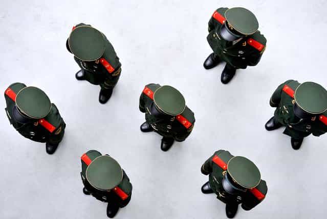 Chinese soldiers stand in line at World Expo 2010 in Shanghai, prior to the China national pavilion day, which also marked the 61st anniversary of the founding of the People's Republic of China. (Photo by Philippe Lopez/AFP Photo)