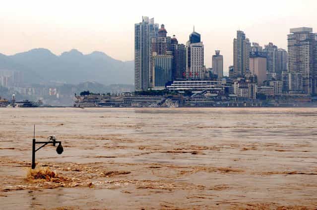 A street lamp is partially submerged by the flooded Yangtze River in southwest China's Chongqing city. (Photo by Associated Press)