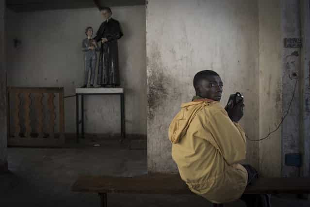 [Kamara Serbungo, 17, fled Rubabe (Rutshuru territory, North Kivu province of the Democratic Republic of the Congo) when rebel M23 soldiers entered the house of his family to forcibly enlist him. As a refugee in the Kanyaruchinya camp, he fled a second time when the M23 took over Goma. With other displaced persons he's now taking shelter at the Don Bosco parish]. (Photo and comment by Colin Delfosse, Belgium/2013 Sony World Photography Awards