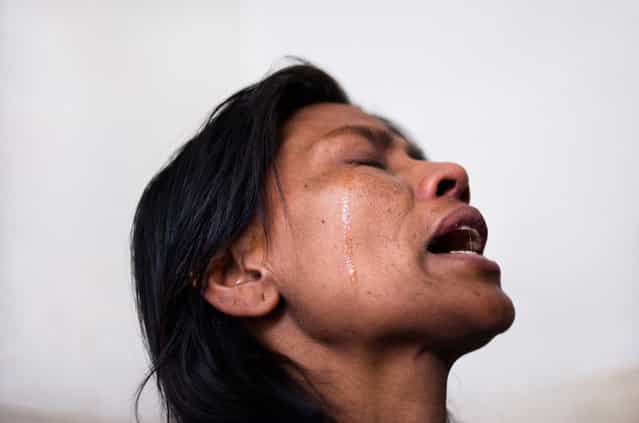 [Pobitra Tapa mourns alone in agony, painful tears of frustration for a life wasting away, withering from HIV and a tumor in her young body. She cried, away from the eyes of her already suffering husband who has been looking after her for several weeks at the Pkohara hospital in Nepal. Losing any sense of hope, this mother of two was once an alcoholic and suspects that she got HIV-tainted blood in a transfusion years ago. Feeling alone and useless, the disease that eats up her body still allows her the strength to show firmness in front of her family but suffer a lonely pain]. (Photo and comment by Miguel Candela, Spain/2013 Sony World Photography Awards