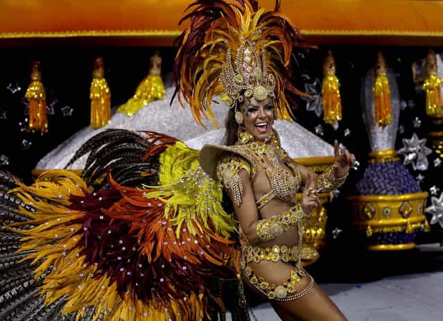 A dancer from the Gavioes da Fiel samba school performs during a carnival parade in Sao Paulo, Brazil, early Sunday, February 10, 2013. (Photo by Andre Penner/AP Photo)